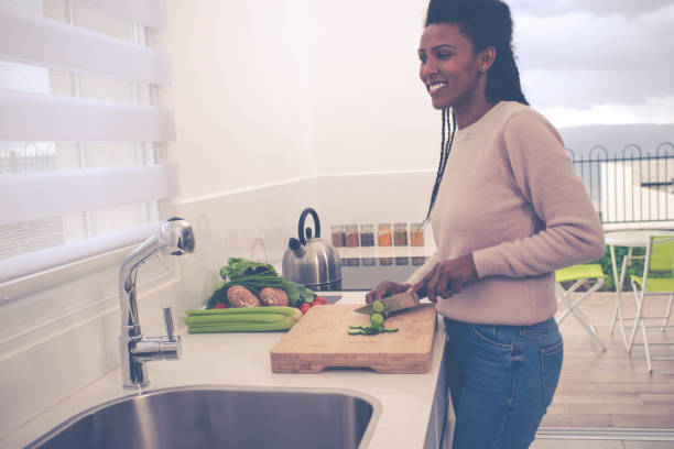 istock Woman preparing salad in the kitchen. 1211861615