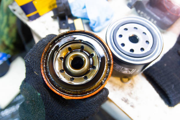 istock Replacing the oil filter on a car engine. new and old filter. 1211864776