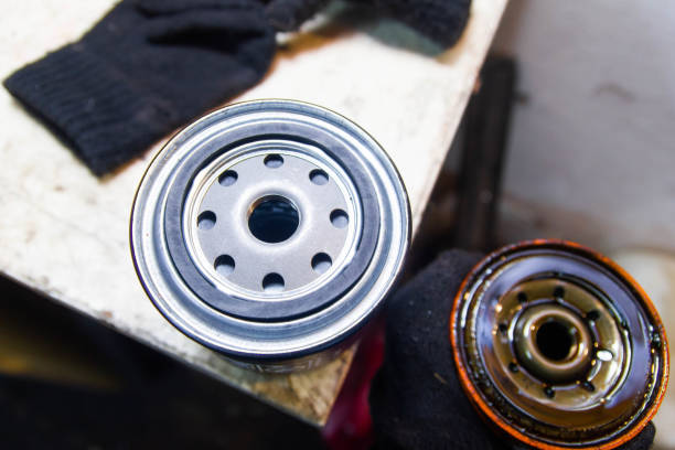 istock Replacing the oil filter on a car engine. new and old filter. 1211864796