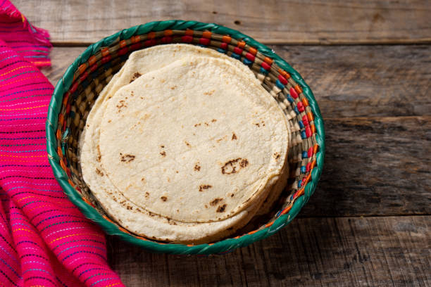 istock Mexican corn tortillas on wooden background 1211868051