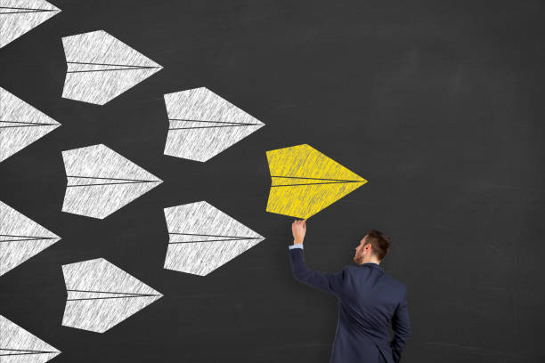 istock Leadership Concepts with Airplanes on Chalkboard Background 1211868850
