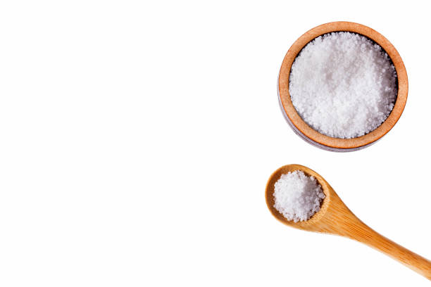 istock sea salt on wooden spoon isolated from white background 1211868897