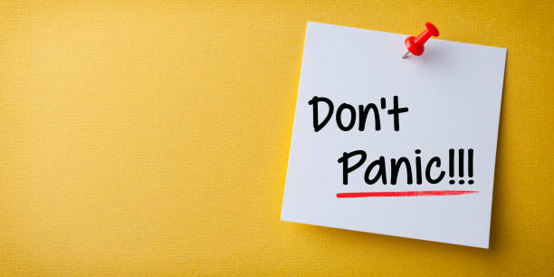 istock White Sticky Note With Don't Panic And Red Push Pin On Yellow Background 1211869067