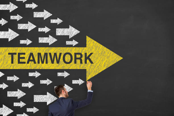 istock Teamwork Concepts with Arrows on Chalkboard Background 1211869439