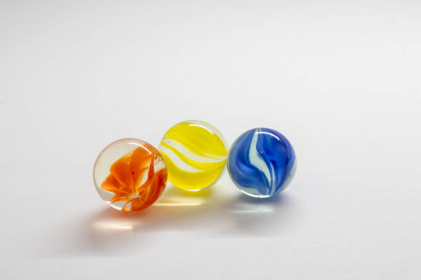 istock Colourful toy marbles against a white background 1211869460