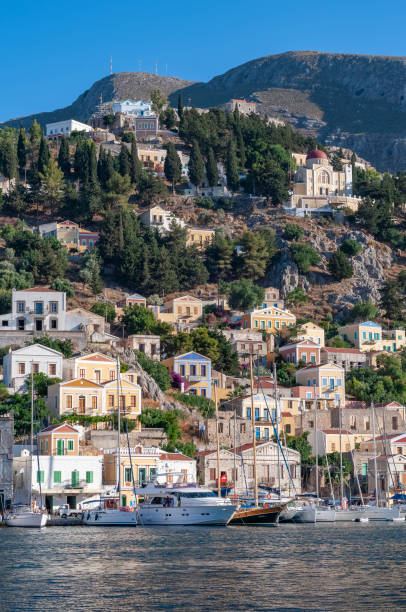 istock Building facades surrounding harbour Symi Town 1211870823