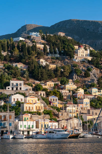 istock Building facades surrounding harbour Symi Town 1211870895