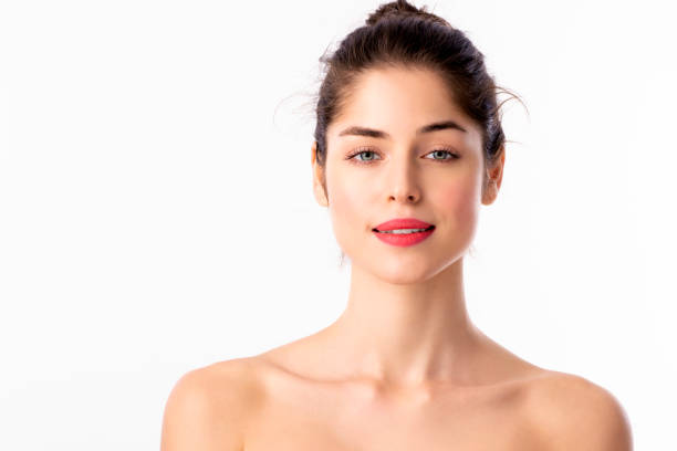 istock Beautiful young woman wearing red lipstick while posing at isolated white background 1211871961