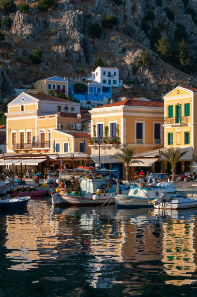 istock Fishing boats in harbour Symi Town 1211872432