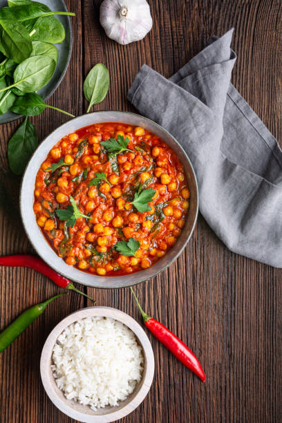 istock Indian meal, spicy chickpea curry with spinach in a bowl served with rice 1211875261