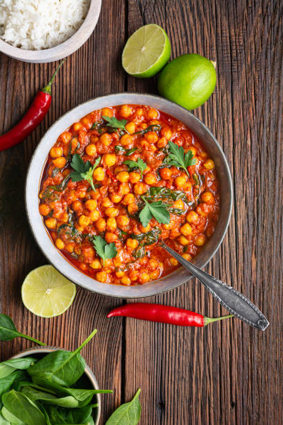 istock Indian meal, spicy chickpea curry with spinach in a bowl served with rice 1211875772