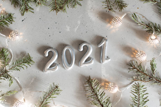 istock New Year 2021 silver balloons with fireworks 1211878145