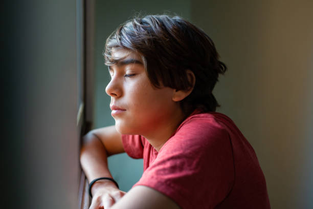 istock latinx preadolescent boy with closed eyes, reflecting, relaxing, pensive. 1211879059