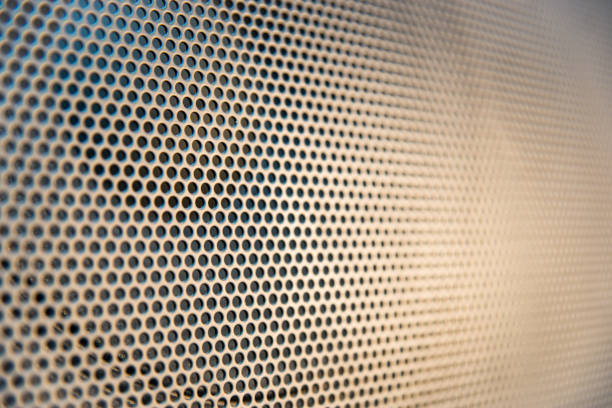 istock Black speaker grill with holes 1211879167