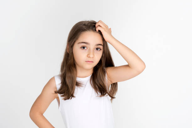 istock Excited girl holding hands on head, looking at camera 1211879396