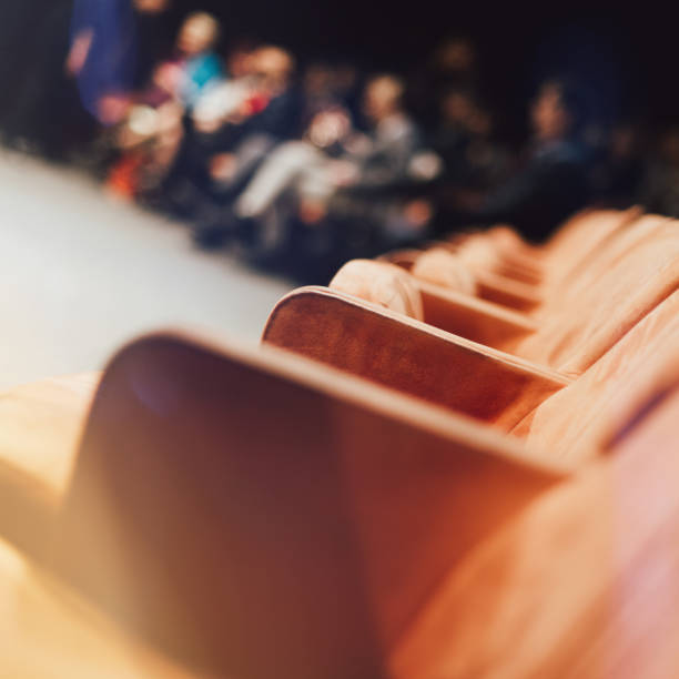 istock Empty comfortable orange seats with numbers in cinema 1211880436