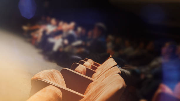 istock Empty comfortable orange seats with numbers in cinema 1211880449