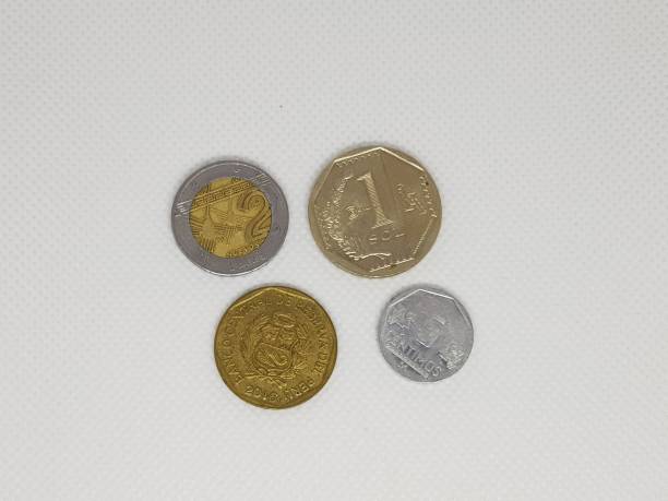 istock Some peruvian coins in a white background Pesos 1211886548