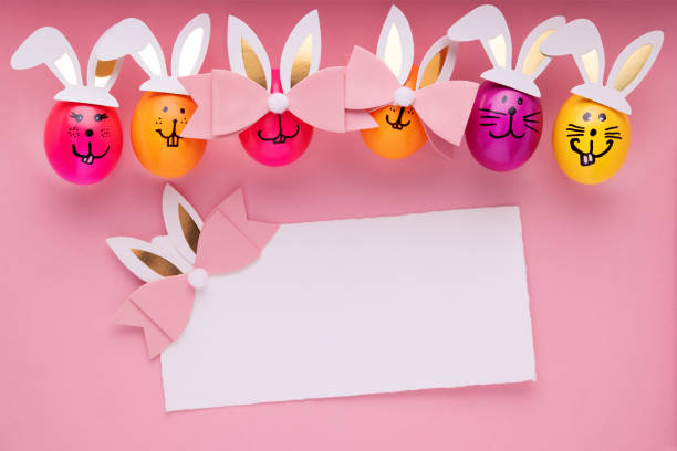 Easter decoration on pink background with an empty card