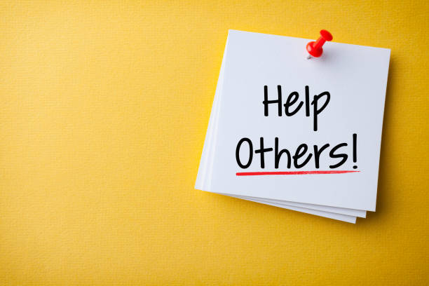 istock White Sticky Note With Help Others And Red Push Pin On Yellow Background 1211891858