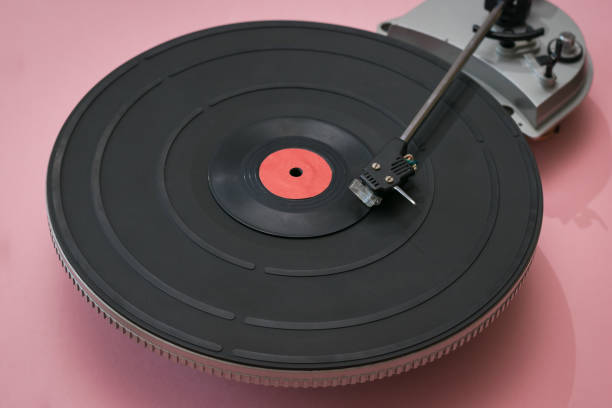 istock Vintage vinyl record player on a pink background. 1211894331