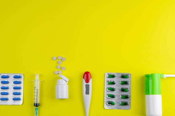 istock Pills, syringe, inhaler, thermometer, spray on a yelow background 1211894544