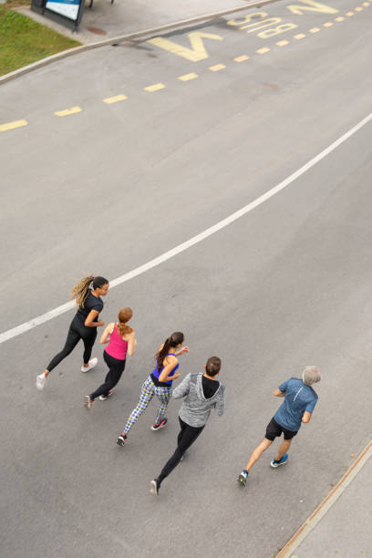 istock Group of People Running in the City 1211896809
