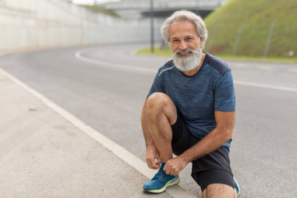 istock Senior Male Runner Tying Up His Shoelaces 1211896814