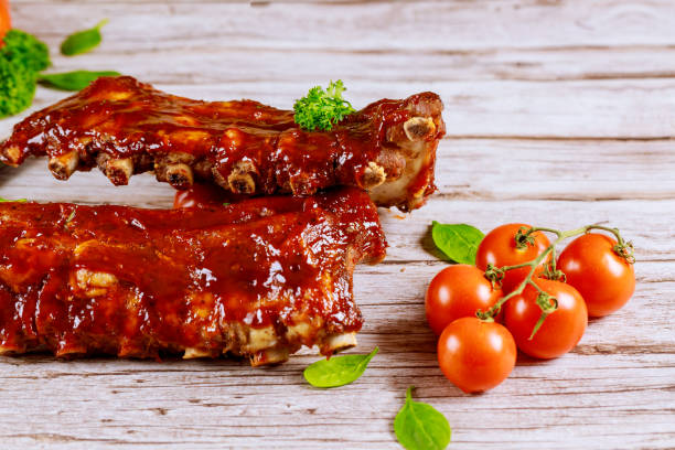 istock Pork ribs grilled with BBQ sauce , tomato and spinach. 1211901111