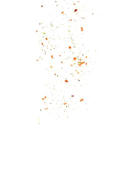 Crushed seasoning with dry vegetables, chili flakes and cayenne pepper isolated on white background. Flying or sifting seasoning.