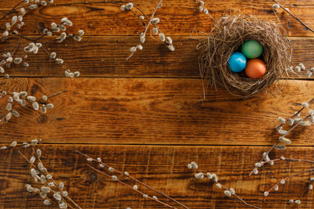 istock Still life of easter eggs in a bird's nest on a wooden background. Rustic. Easter celebration concept. Flat lay 1211908269