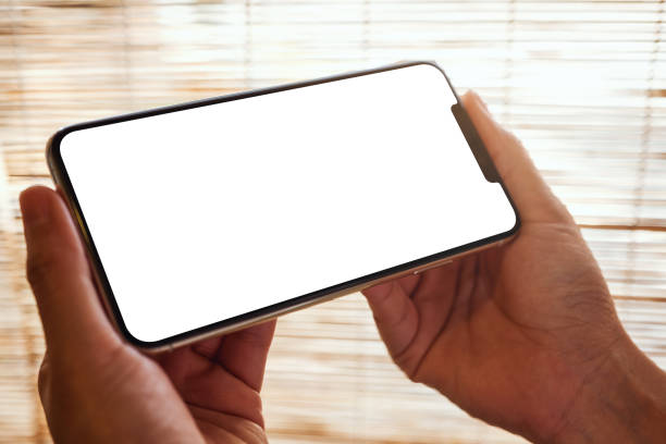istock a woman holding mobile phone with blank white desktop screen 1211909325