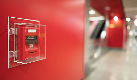 Fire alarm on the wall in subway in Bangkok,  At the Bangkok subway fire warning equipment for emergency. It's red fire alarm switch  on the wall. Founded un everywhere for the public area.