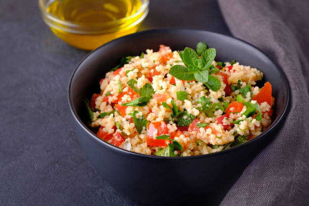 istock Tabbouleh salad in black bowl on black stone surface 1211921860