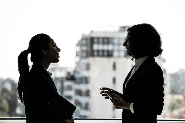 istock Confident female coworkers discussing project 1211924941