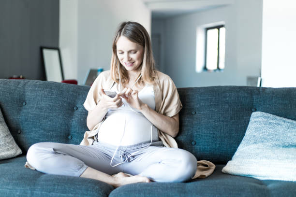 istock Happy expectant mother watching content 1211926204