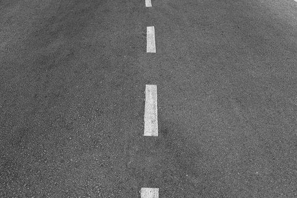 istock Asphalt road with marking lines white stripes texture Background. 1211927316
