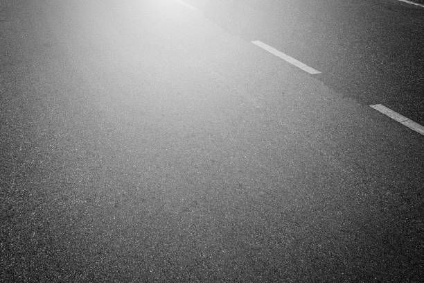 istock Asphalt road with marking lines white stripes texture Background. 1211927561