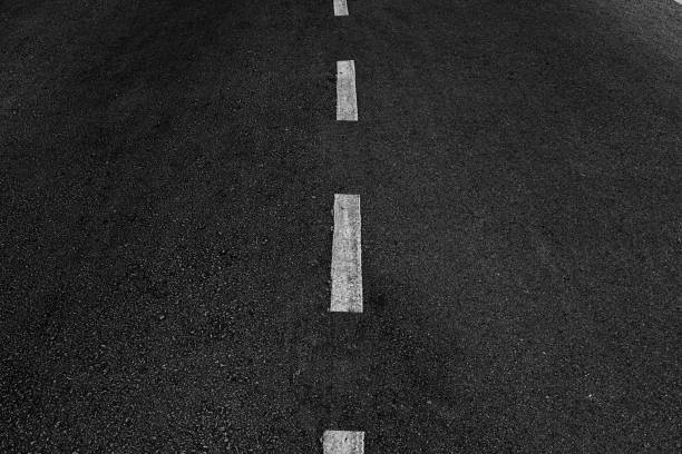 istock Asphalt road with marking lines white stripes texture Background. 1211927609