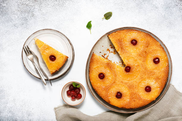 istock Sliced upside down pineapple cake with candied cherries and caramel. 1211928935
