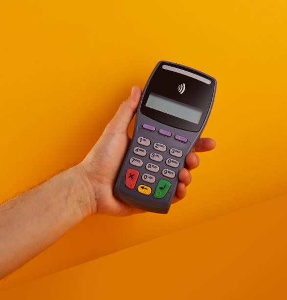 istock Wireless, contactless credit card reader. Electronic banking terminal in hand 1211930162