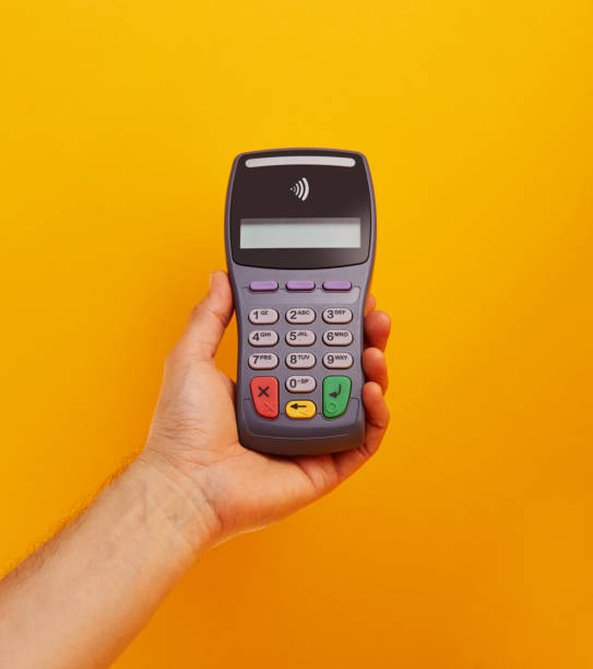 istock Wireless, contactless credit card reader. Electronic banking terminal in hand 1211930163