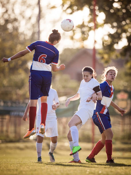 istock Heading the ball on women's soccer match! 1211930963