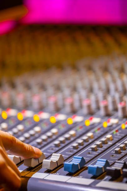 istock sound engineer fingers adjusting on audio mixing console fader. recording, broadcasting concept 1211931016