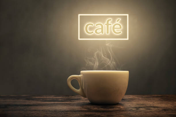 Steaming cup under a glowing café sign A white coffee cup on a wooden surface. The cup gets illuminated by a "café" sign above. tasse café stock pictures, royalty-free photos & images