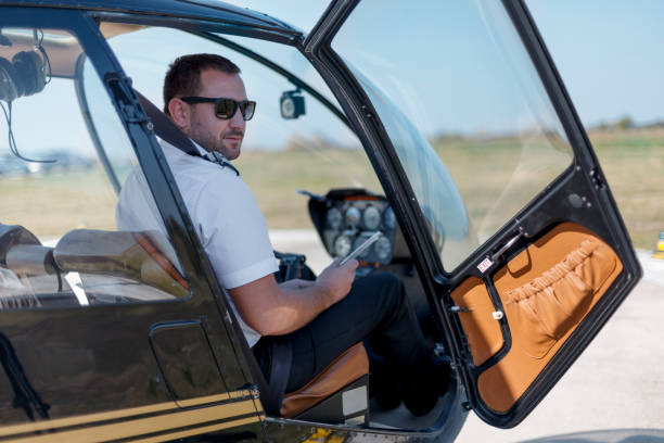 istock Helicopter pilot sitting in cockpit and waiting for flight 1211931855