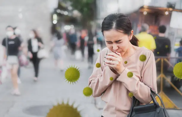 Coronavirus covid-19 concept, Unhealthy Asian woman sneezing and cough without protective face mask, ill, sick, from virus and air pollution PM2.5