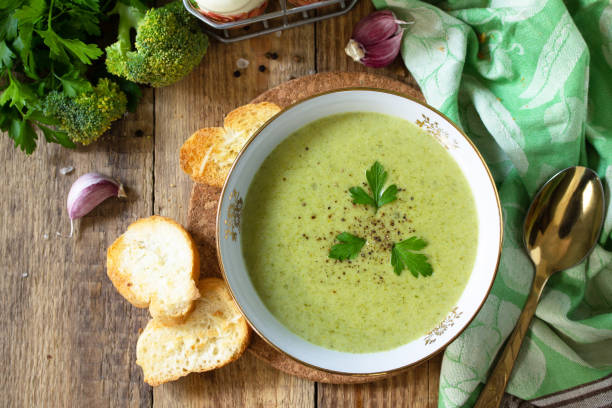 istock Vegetarian dish. Delicious broccoli cream soup served with garlic croutons on a rustic table. Top view flat lay background. 1211939925