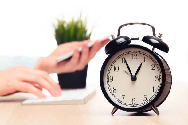 istock alarm clock on the background of the office 1211940971