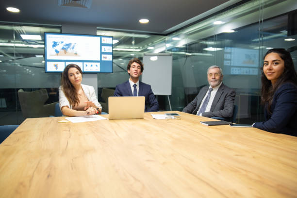 istock Confident business team sitting at table in conference room 1211941981